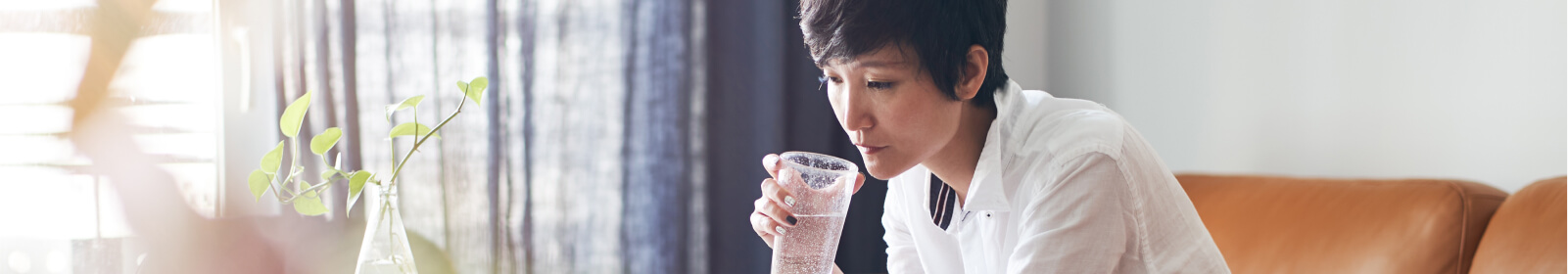 a woman holding a glass of water