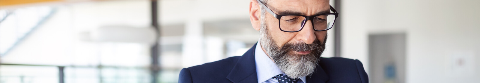 a man in a suite wearing glasses