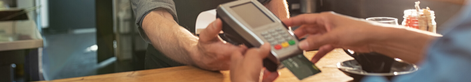 a person using a card reader to make a payment