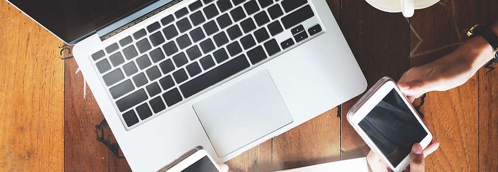 a laptop, mobile open sitting on a table