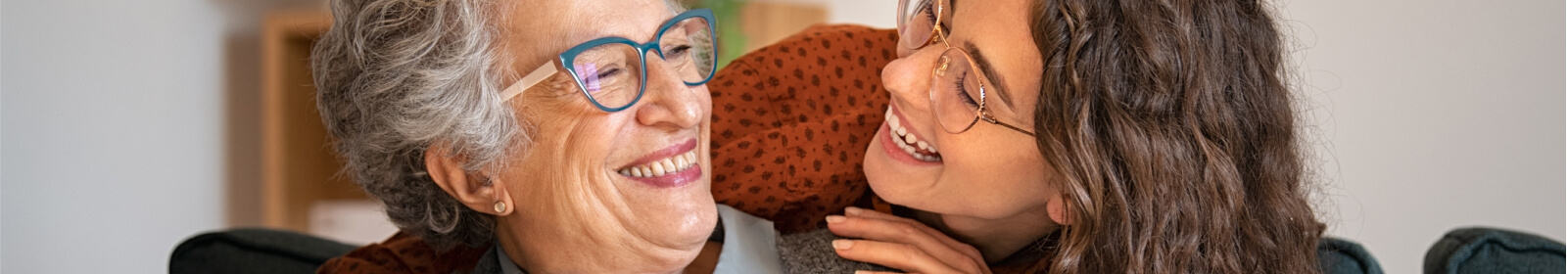 a mother and daughter smiling